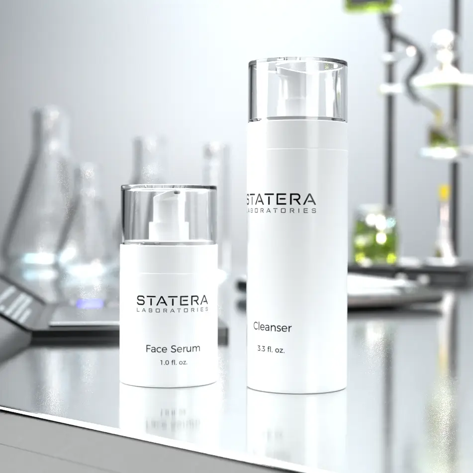 STATERA Laboratories Face Serum and STATERA Laboratories Cleanser on lab table with lab equipment in background.